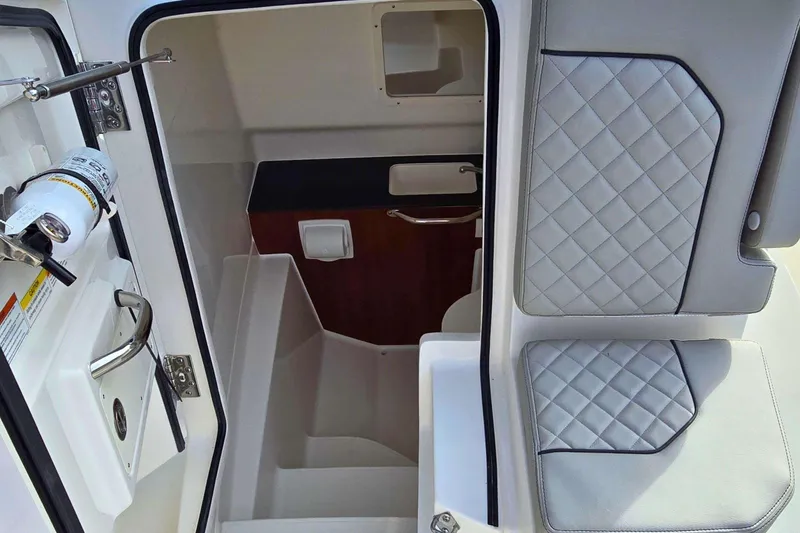Slide: The Image of Interior view of 2025 Pursuit S 288 Sport boat, featuring seating and storage. - 13