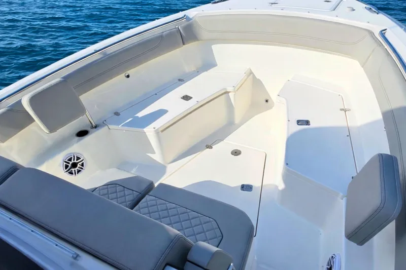 Slide: The Image of 2025 Pursuit S 288 Sport boat interior with cushioned seating and ocean backdrop. - 15