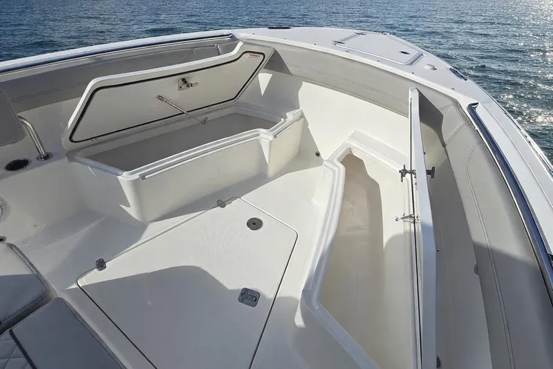Slide: The Image of 2025 Pursuit S 288 Sport boat with open storage compartments on deck. - 16