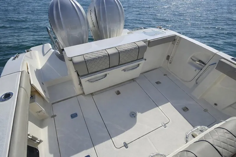 Slide: The Image of 2025 Pursuit S 288 Sport boat deck with dual engines on calm water. - 2