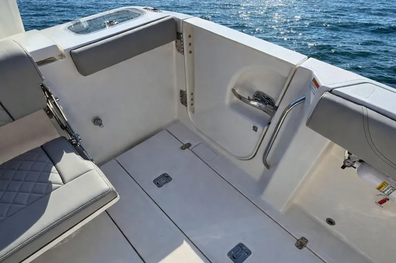 Slide: The Image of 2025 Pursuit S 288 Sport boat interior with cushioned seating and ocean view. - 4