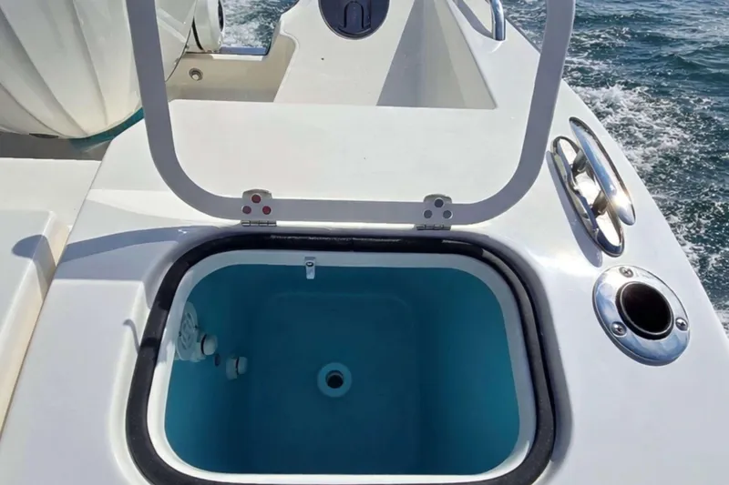Slide: The Image of Open hatch on 2025 Pursuit S 288 Sport boat, revealing storage compartment. - 5