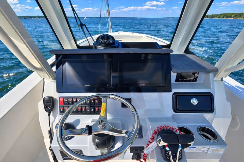 Slide: The Image of Helm of 2025 Pursuit S 288 Sport boat with dual screens and steering wheel. - 8