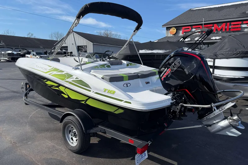 Slide: The Image of 2022 Tahoe T18 boat with outboard motor on trailer at dealership. - 13