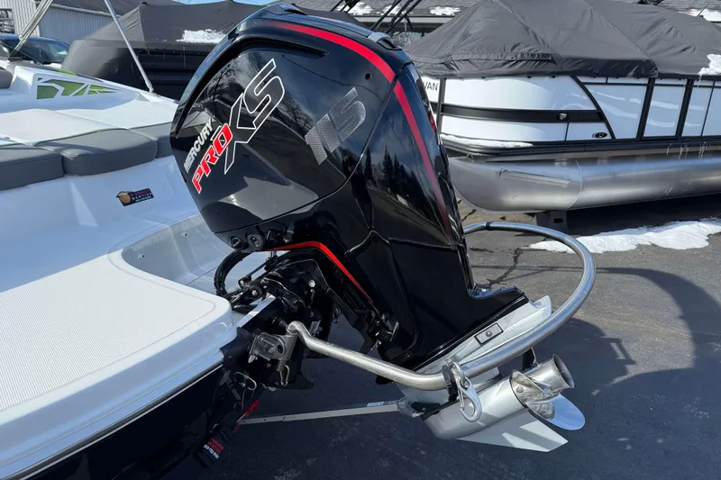 Slide: The Image of 2022 Tahoe T18 boat with Mercury Pro XS outboard motor, parked near other boats. - 14