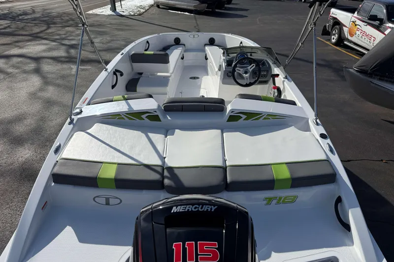 Slide: The Image of 2022 Tahoe T18 boat interior with Mercury 115 engine, featuring modern seating and steering console. - 2