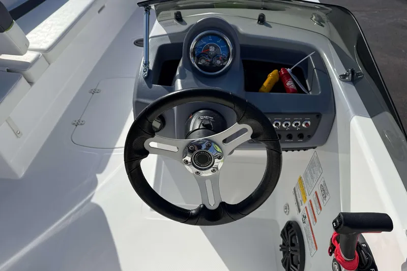 Slide: The Image of 2022 Tahoe T18 boat dashboard with steering wheel and control panel. - 7