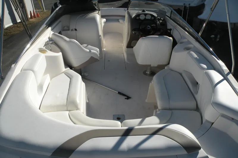 Slide: The Image of 2005 Regal 2400 Bowrider interior with white seating and steering console. - 10
