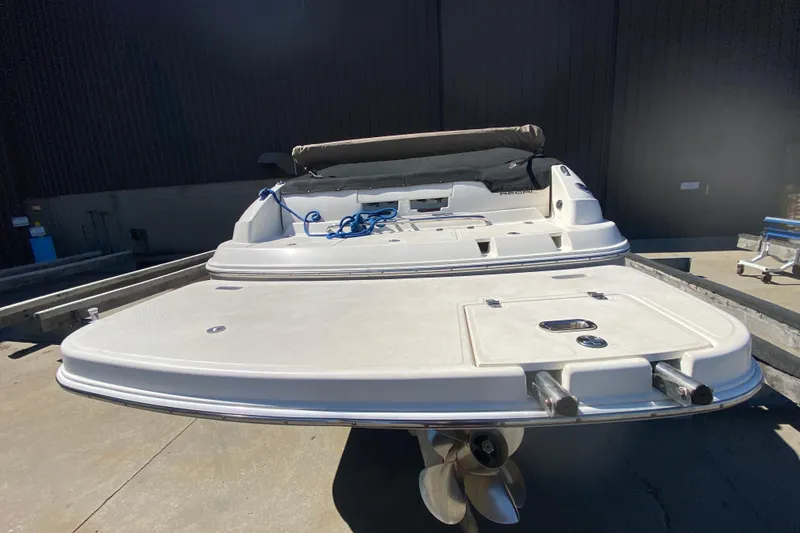 Slide: The Image of 2005 Regal 2400 Bowrider boat on trailer, rear view with propeller visible. - 6