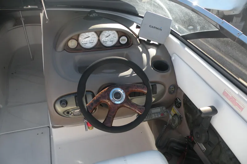 Slide: The Image of 2005 Regal 2400 Bowrider dashboard with steering wheel and Garmin navigation system. - 9