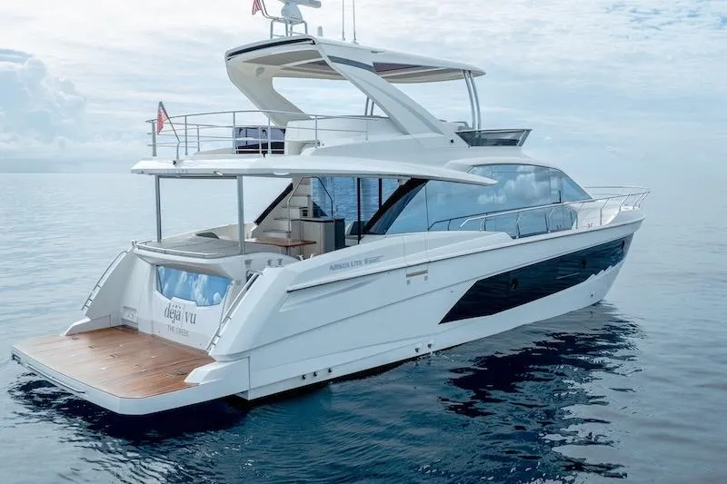 Slide: The Image of 2023 Absolute 62 Fly yacht on calm ocean waters, showcasing sleek design and luxury features. - 10