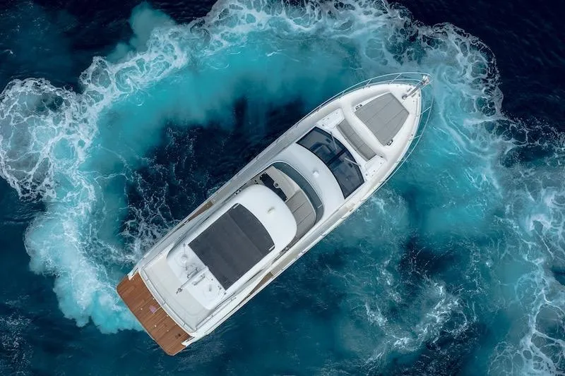 Slide: The Image of Aerial view of 2023 Absolute 62 Fly yacht navigating through vibrant blue ocean waters. - 11