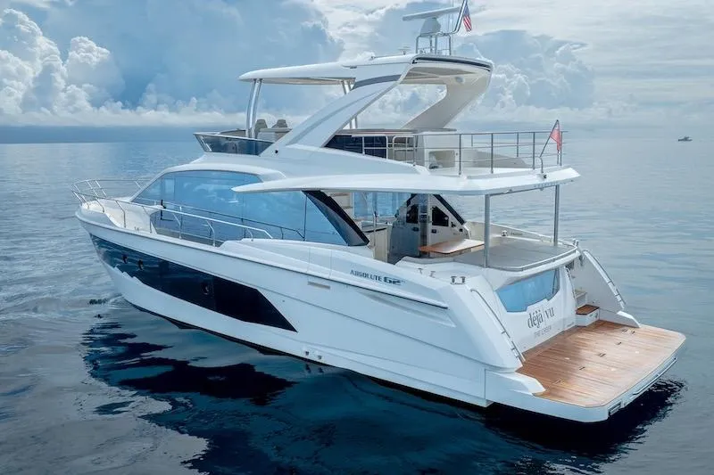 Slide: The Image of 2023 Absolute 62 Fly yacht on calm ocean waters under cloudy sky. - 12