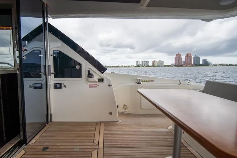 Slide: The Image of 2023 Absolute 62 Fly yacht deck with ocean view and city skyline. - 14