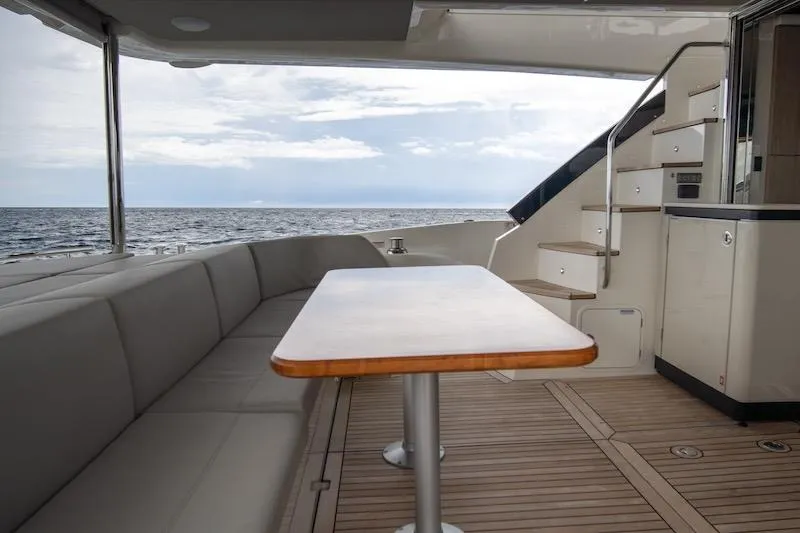 Slide: The Image of Luxurious 2023 Absolute 62 Fly yacht deck with seating, table, and ocean view. - 16
