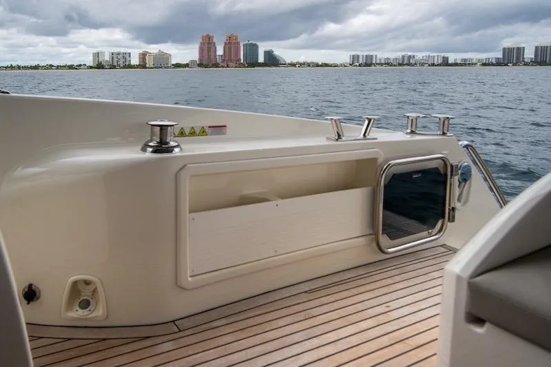 Slide: The Image of 2023 Absolute 62 Fly yacht deck with city skyline in background. - 17