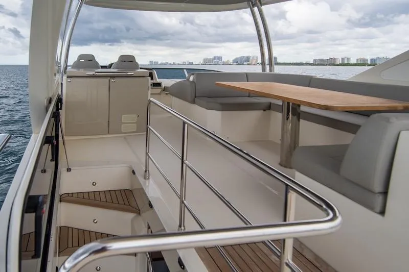 Slide: The Image of Luxurious 2023 Absolute 62 Fly yacht interior with seating and table, overlooking the ocean. - 19