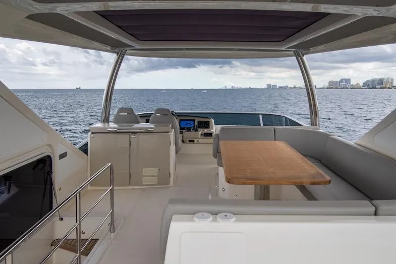 Slide: The Image of Luxurious 2023 Absolute 62 Fly yacht interior with ocean view, featuring seating and table. - 20