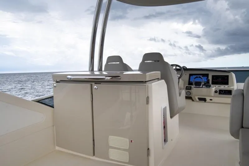 Slide: The Image of 2023 Absolute 62 Fly yacht helm with modern controls and ocean view. - 24