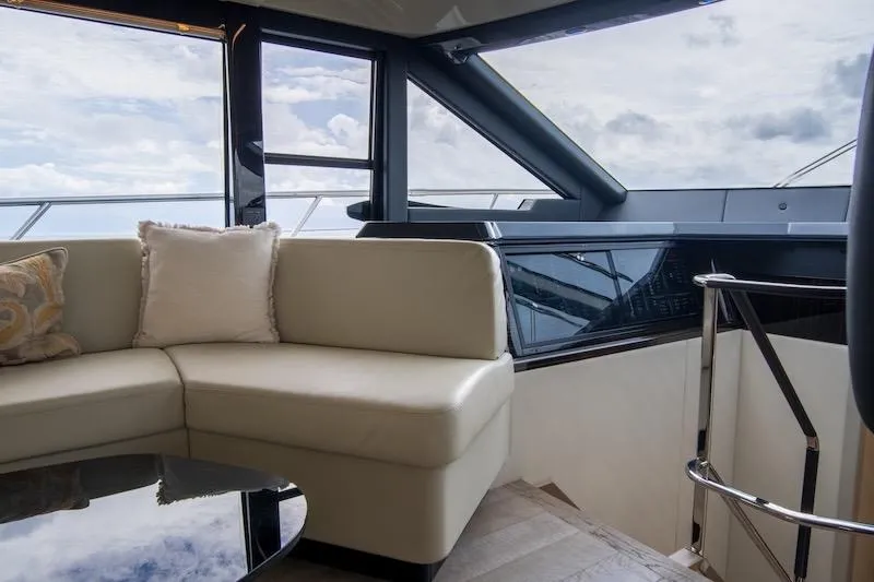Slide: The Image of Luxurious interior of 2023 Absolute 62 Fly yacht with plush seating and panoramic windows. - 42