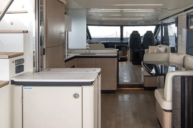 Slide: The Image of Luxurious interior of 2023 Absolute 62 Fly yacht with modern kitchen and seating area. - 49