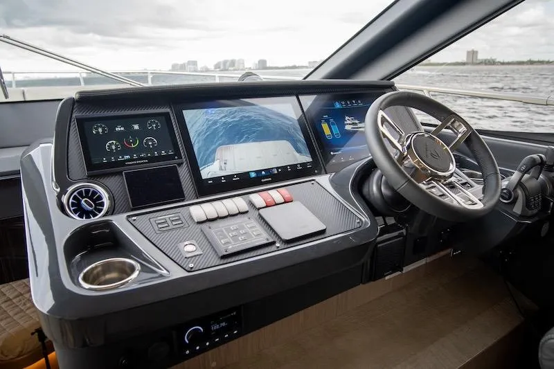 Slide: The Image of 2023 Absolute 62 Fly yacht helm with advanced navigation displays and controls. - 52