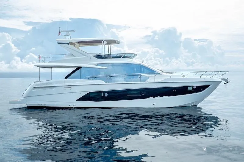 Slide: The Image of 2023 Absolute 62 Fly yacht on calm ocean waters under cloudy sky. - 6