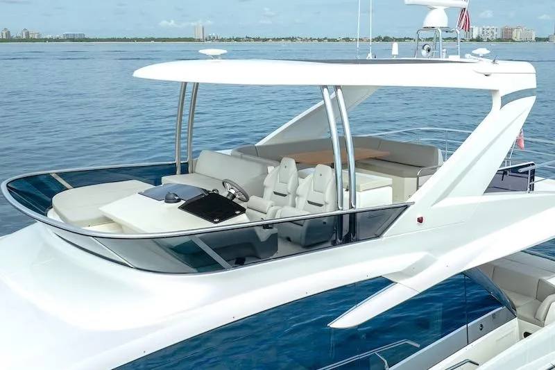 Slide: The Image of 2023 Absolute 62 Fly yacht with sleek design and spacious flybridge on calm waters. - 9
