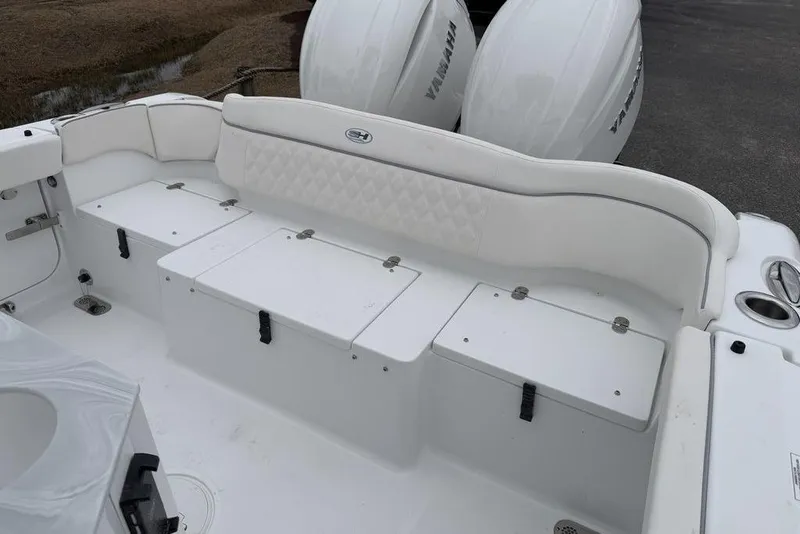 Slide: The Image of 2026 Sea Hunt Ultra 265 SE boat interior with cushioned seating and storage compartments. - 12