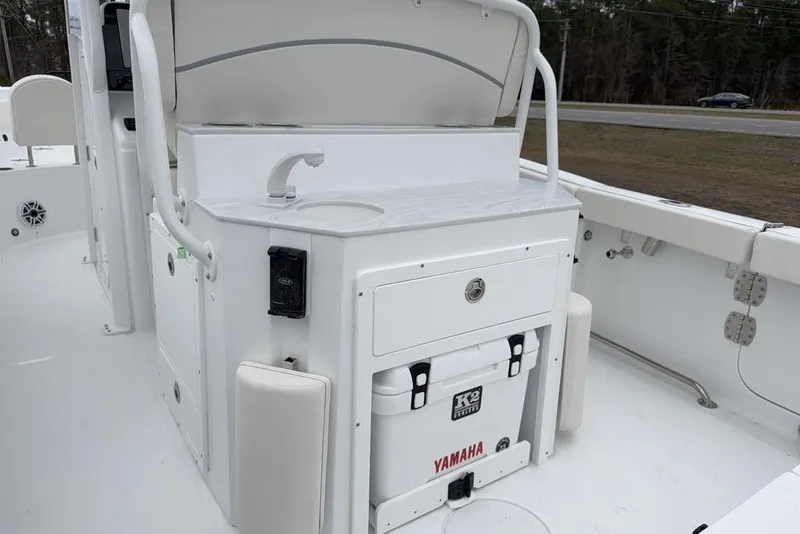 Slide: The Image of 2026 Sea Hunt Ultra 265 SE boat interior with sink and storage area. - 13
