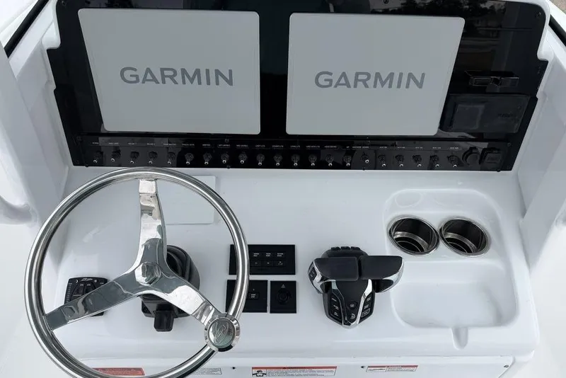 Slide: The Image of Steering console of 2026 Sea Hunt Ultra 265 SE with Garmin displays and controls. - 15