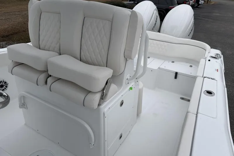 Slide: The Image of 2026 Sea Hunt Ultra 265 SE boat interior with dual seats and white upholstery. - 16