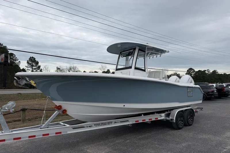 Slide: The Image of 2026 Sea Hunt Ultra 265 SE boat on trailer, parked outdoors. - 4
