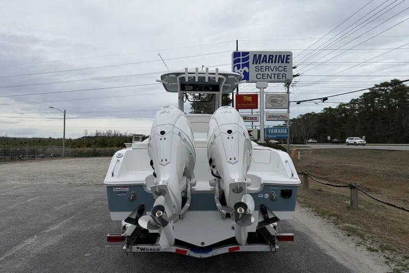 Slide: The Image of 2026 Sea Hunt Ultra 265 SE boat at marine service center with dual engines. - 6