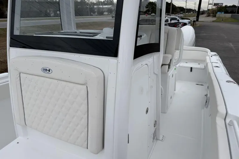 Slide: The Image of 2026 Sea Hunt Ultra 265 SE boat interior with white seating and sleek design. - 8