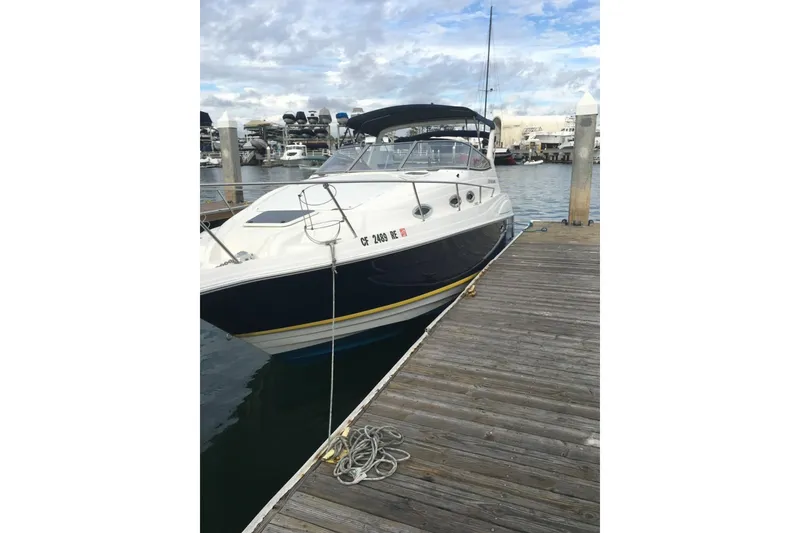 Slide: The Image of 2003 Regal Commodore 2860 boat docked at marina with clear sky background. - 2