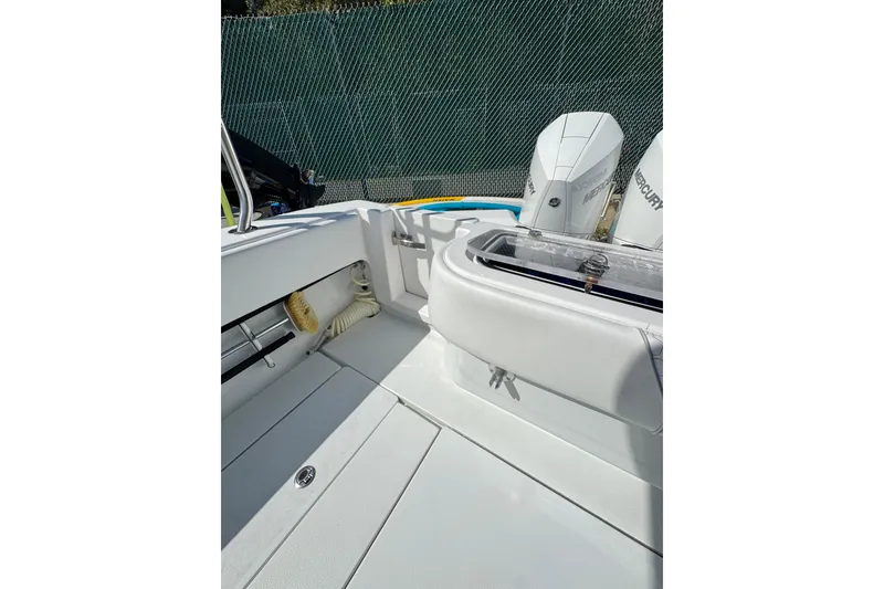 Slide: The Image of 2025 Contender 30 Tournament boat interior with Mercury engines and storage compartments. - 19