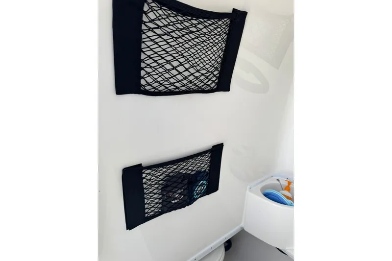 Slide: The Image of Interior storage nets on 2025 Contender 30 Tournament boat, featuring organized compartments. - 24