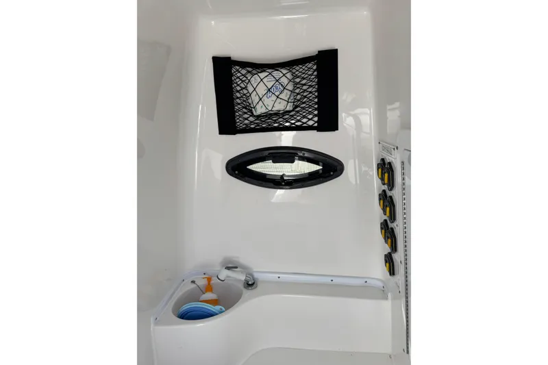 Slide: The Image of Interior of 2025 Contender 30 Tournament boat with storage net and control panel. - 26