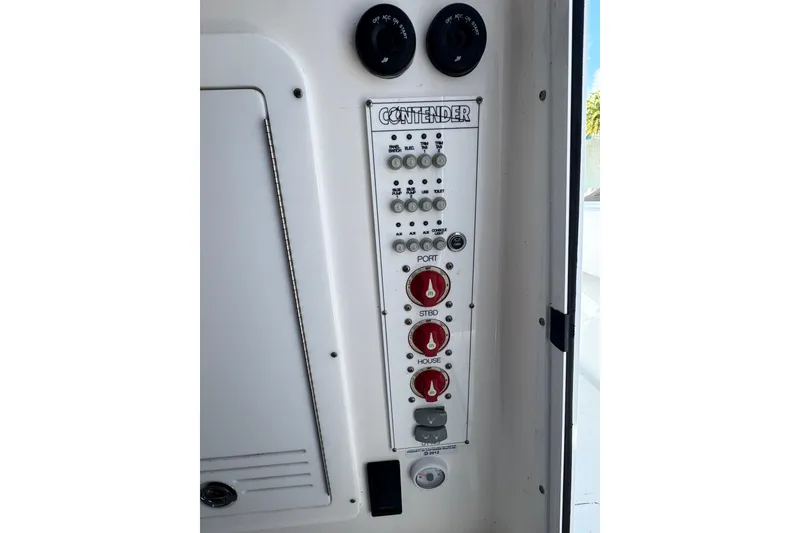 Slide: The Image of Control panel of 2025 Contender 30 Tournament boat with switches and dials. - 28