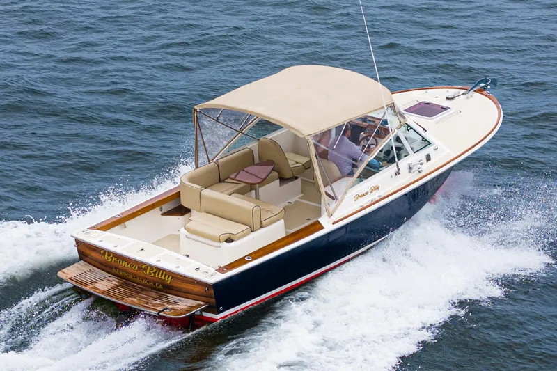 The Image of 2006 Hunt Yachts Harrier 25 cruising on water, featuring beige canopy and seating. - 0