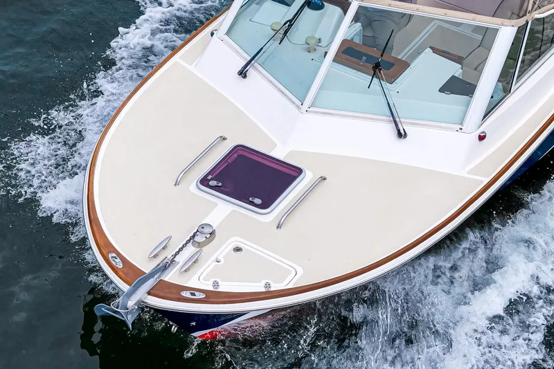 Slide: The Image of 2006 Hunt Yachts Harrier 25 cruising on water, showcasing sleek design and craftsmanship. - 12