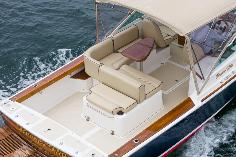 Slide: The Image of 2006 Hunt Yachts Harrier 25 with beige seating and canopy on the water. - 15