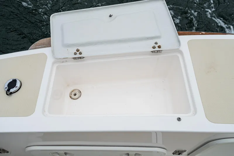 Slide: The Image of Open storage compartment on 2006 Hunt Yachts Harrier 25 boat, with ocean background. - 18