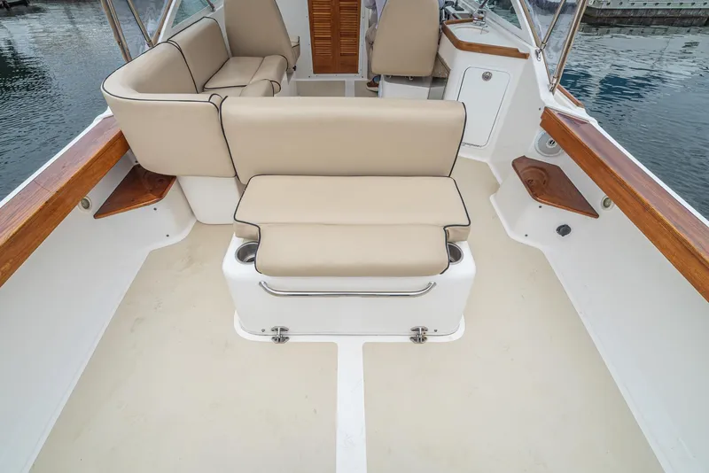 Slide: The Image of 2006 Hunt Yachts Harrier 25 interior with beige seating and wooden accents. - 19