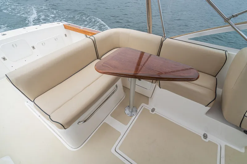 Slide: The Image of Luxurious seating area on 2006 Hunt Yachts Harrier 25 with wooden table. - 22
