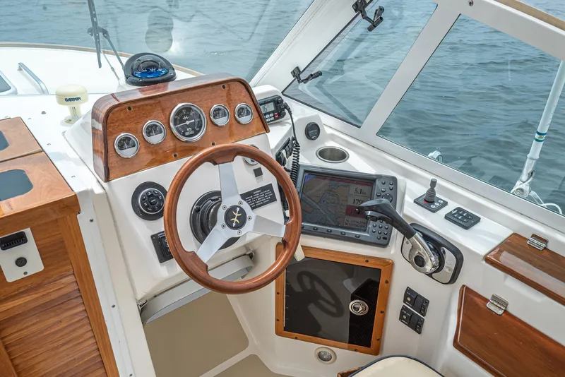 Slide: The Image of 2006 Hunt Yachts Harrier 25 cockpit with wooden dashboard and modern navigation equipment. - 27