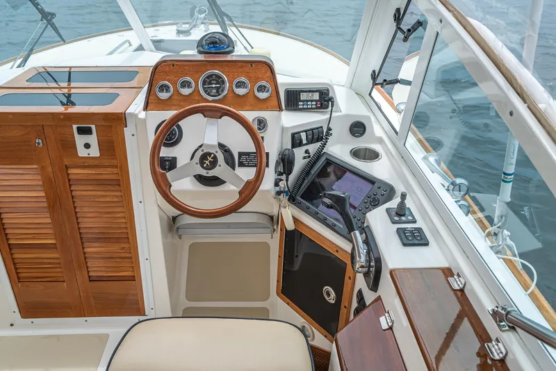 Slide: The Image of 2006 Hunt Yachts Harrier 25 cockpit with wooden steering wheel and navigation instruments. - 28