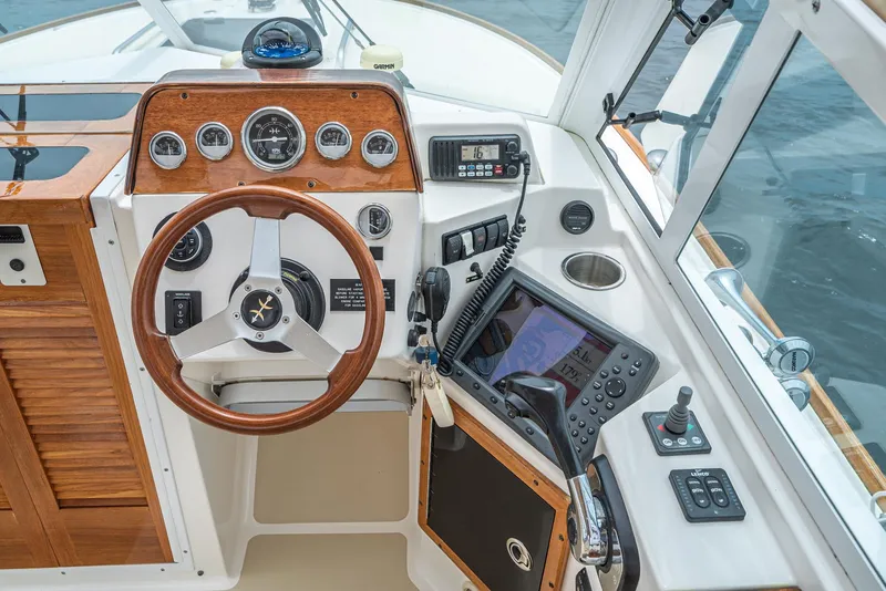 Slide: The Image of 2006 Hunt Yachts Harrier 25 cockpit with wooden steering wheel and navigation instruments. - 29