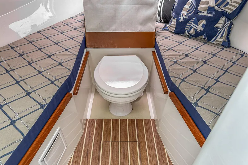 Slide: The Image of 2006 Hunt Yachts Harrier 25 cabin interior with toilet and cushioned seating. - 34